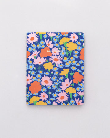 blue to-do planner with colorful pink, orange, yellow and blue floral print with 'DAILY PLANNER' across the front